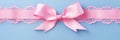 Decorative beautiful pink satin ribbon with bow for decorate gift box or greeting card on light blue background. Royalty Free Stock Photo