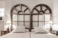 Decorative bedroom headboard with matching wooden twin beds, cushions,