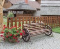 Decorative bench near the wooden fence ethnic houses made from Royalty Free Stock Photo