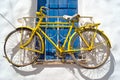 Decorative bicycle hanging from a window in a Greek house Royalty Free Stock Photo