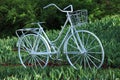 Decorative bicycle made of metal. City garden in the spring