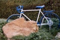 Decorative bike standing in the garden like a flower pot