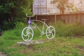 Decorative bike in the sunny light of a hot day. Toned background