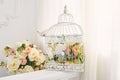 Decorative bird cage with bouquet of flowers in the interior Royalty Free Stock Photo