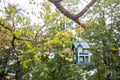 Decorative bird house on tree in summer park Royalty Free Stock Photo