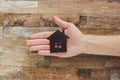 Decorative black house in the hand