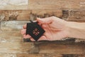 Decorative black house in the hand