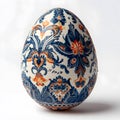 Decorative blue Easter egg with intricate floral patterns, displayed on a stand and isolated on a white background, perfect for Royalty Free Stock Photo