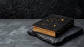 A decorative book with a starry design on a stone surface Royalty Free Stock Photo