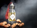 Decorative bottle with iron embossed in traditional Moroccan style with precious Moroccan argan oil and argan nuts on a