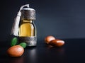 Decorative bottle with iron embossed in traditional Moroccan style with precious Moroccan argan oil and argan nuts on a