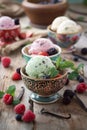 Decorative bowls filled with colorful ice cream and berries, a feast for the eyes and the palate.