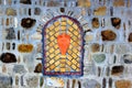 Decorative bricked window in a stone wall