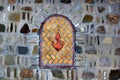 Decorative bricked window in a stone wall