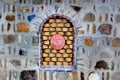 Decorative bricked window in a stone wall