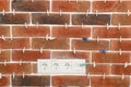Decorative bricks with tile leveling system on wall Royalty Free Stock Photo