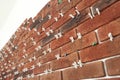 Decorative bricks with tile leveling system on white wall Royalty Free Stock Photo