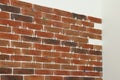 Decorative bricks with tile leveling system on white wall Royalty Free Stock Photo