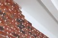Decorative bricks with tile leveling system on white wall in repaired room Royalty Free Stock Photo