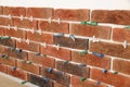 Decorative bricks with tile leveling system on white wall in room