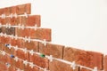 Decorative bricks with tile leveling system on white wall in room Royalty Free Stock Photo