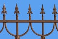 Decorative bronze fence isolated on blue