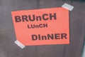 Decorative `brunch,Lunch,Dinner` sign at restaurant door orange paper background Royalty Free Stock Photo