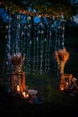 Night wedding ceremony with a lot of lights, candles, lanterns. Beautiful romantic shining decorations in twilight