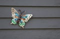 Decorative butterfly adorning outside wall of home