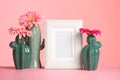 Decorative cacti, flowers and photo frame on table