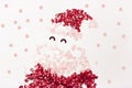 Decorative cartoon children`s Santa Claus with a beard and a hat, laid out of red and pink sequins on a white background with Royalty Free Stock Photo