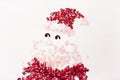 Decorative cartoon children`s Santa Claus laid out of red and pink sequins on an isolated white background Royalty Free Stock Photo