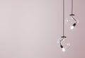 Decorative ceiling lights hanging lights on pink background with copy space. 3d rendering