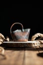 Decorative ceramic clay milk jug hand made on a stand on a wooden table made of aged boards, rope rope made of jute Royalty Free Stock Photo