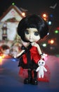 Decorative ceramic monster doll with black hair and a red dress for Halloween