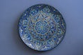 Decorative ceramic plate with blue and golden colors, painted plates, closeup. Decorative porcelain plate painted with acrylic Royalty Free Stock Photo