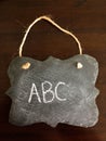 Decorative Chalkboard with ABC spelled on Wood Background
