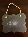 Decorative Chalkboard with I do spelled in chalk on wood Background