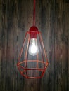 Decorative chandelier with light bulb. Decorative chandelier on wood background