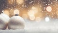 Decorative christmas baubles in snowfall against bokeh background. Selective focus and shallow depth of field Royalty Free Stock Photo