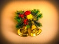 Decorative Christmas bells with green twigs and gold and red tiny ornaments - dark vignetting effect Royalty Free Stock Photo