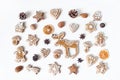 Decorative Christmas food pattern. Winter composition of gingerbread cookies, anise stars, pine cones and dry orange Royalty Free Stock Photo