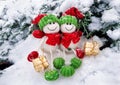 Decorative Christmas and Happy New Year composition of funny two snowmen in hats and scarves with presents seating in the snow. Royalty Free Stock Photo