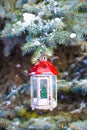 Decorative Christmas lantern on fir branch in snow Royalty Free Stock Photo