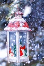 Decorative Christmas lantern on fir branch in snow Royalty Free Stock Photo