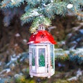 Decorative Christmas lantern on fir branch in snow Royalty Free Stock Photo