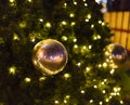 Decorative christmas ornaments baubles on green evergreen branches of a coniferous tree at the christmas markets in Prague Royalty Free Stock Photo