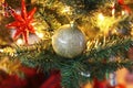 Decorative Christmas ornaments on the tree - golden balls and red star Royalty Free Stock Photo