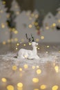 Decorative Christmas-themed figurines. Christmas deer. Christmas tree decoration. Festive decor, warm bokeh lights