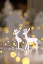 Decorative Christmas-themed figurines. Christmas deer. Christmas tree decoration. Festive decor, warm bokeh lights